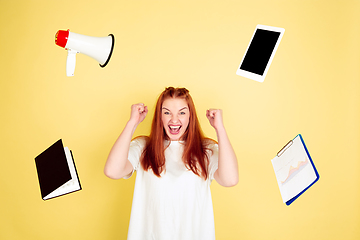 Image showing Caucasian young woman\'s portrait on yellow background, too much tasks