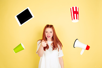 Image showing Caucasian young woman\'s portrait on yellow background, too much tasks