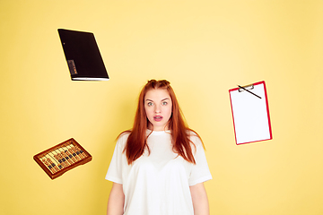 Image showing Caucasian young woman\'s portrait on yellow background, too much tasks