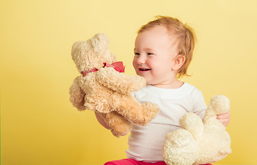 Image showing Caucasian little girl, children isolated on yellow studio background