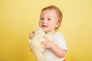 Image showing Caucasian little girl, children isolated on yellow studio background