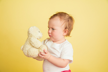 Image showing Caucasian little girl, children isolated on yellow studio background