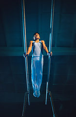 Image showing Little male gymnast training in gym, flexible and active