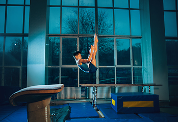 Image showing Little male gymnast training in gym, flexible and active