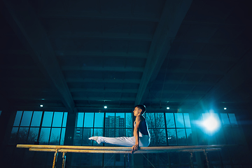 Image showing Little male gymnast training in gym, flexible and active