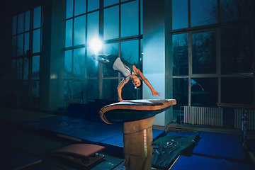 Image showing Little male gymnast training in gym, flexible and active