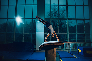 Image showing Little male gymnast training in gym, flexible and active