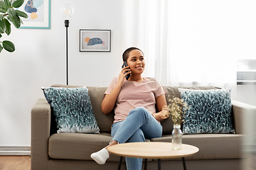 Image showing african woman calling on smartphone at home