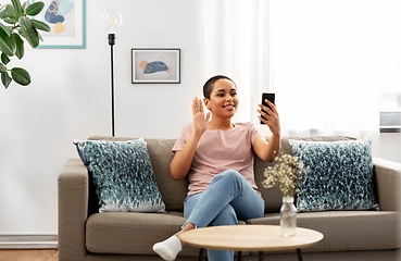 Image showing woman with smartphone having video call at home