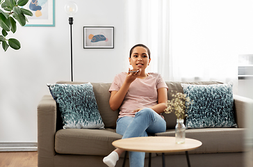 Image showing woman recording voice with smartphone at home