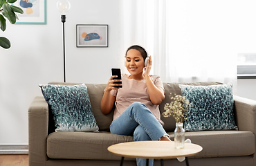 Image showing woman with smartphone listening to music at home