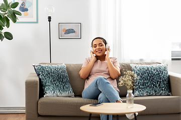 Image showing woman with headphones listening to music at home