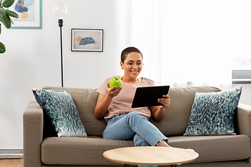 Image showing african woman with tablet pc and apple at home