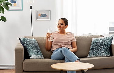 Image showing african american woman with water in glass bottle