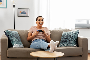 Image showing african american woman with gamepad playing game