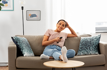 Image showing happy african american woman watching tv at home