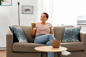 Image showing african american woman drinking smoothie at home