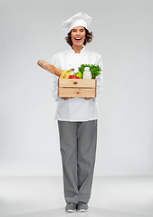 Image showing happy smiling female chef with food in wooden box