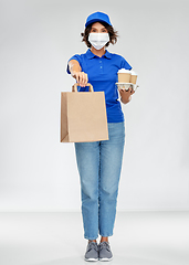 Image showing delivery woman in face mask with food and drinks