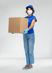 Image showing delivery woman in face mask holding parcel box