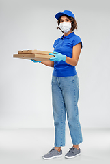 Image showing delivery woman in face mask with pizza boxes