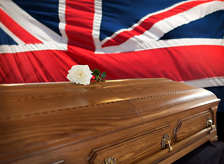 Image showing rose flower on wooden coffin over flag of england