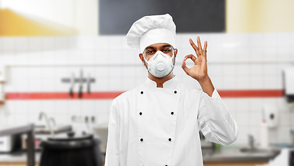 Image showing chef in respirator showing ok sign at kitchen