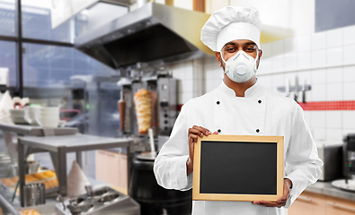 Image showing chef in respirator with chalkboard at kitchen