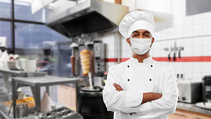 Image showing male chef in face mask at restaurant kitchen