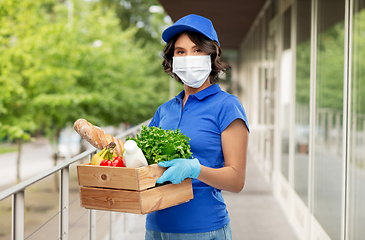 Image showing delivery woman in face mask with food in box