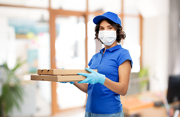 Image showing delivery woman in mask with pizza boxes at office