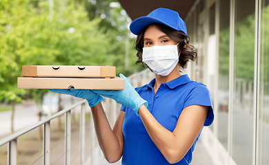 Image showing delivery woman in face mask with pizza boxes