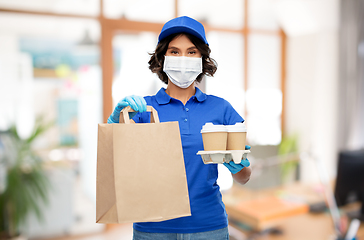 Image showing delivery girl in mask with food at office