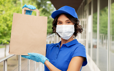 Image showing delivery woman in face mask with food in paper bag