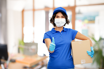 Image showing delivery woman in mask with parcel box at office