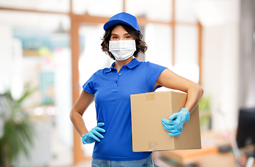 Image showing delivery girl in mask holding parcel box at office