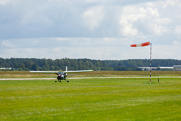 Image showing small plane on green field before take-off outdoors