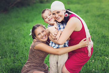 Image showing mother with kids having picnic outdoors