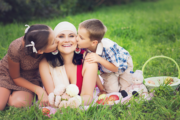 Image showing mother with kids having picnic outdoors