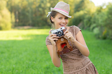 Image showing beautiful teen age girl with retro camera