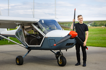 Image showing young man in small plane cockpit