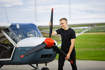 Image showing young man in small plane cockpit