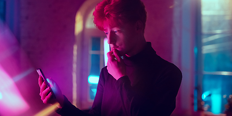 Image showing Cinematic portrait of handsome young man in neon lighted interior