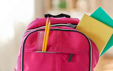 Image showing pink backpack with books and school supplies