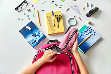 Image showing hands with backpack, books and school supplies