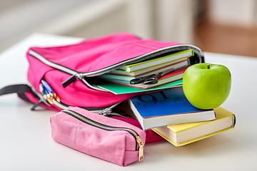 Image showing backpack, apple and school supplies on table