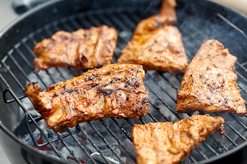 Image showing close up of barbecue meat roasting on grill