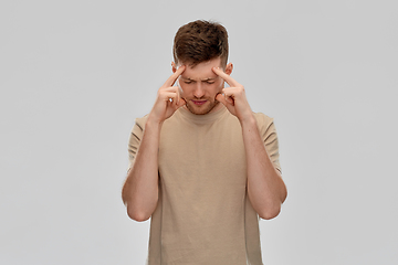 Image showing unhappy man suffering from headache