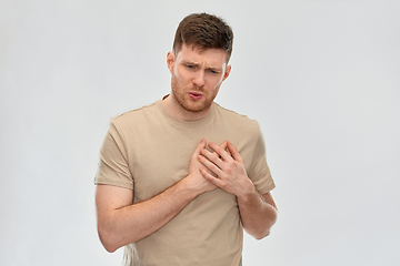 Image showing unhappy young man suffering from heartache