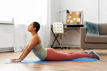 Image showing woman doing cobra yoga pose at home